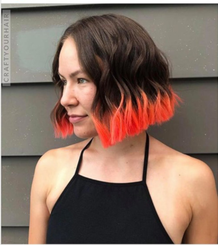 Dip Dyed Hair Is The Festival Trend That Refuses to Retire brown hair with neon coral ends