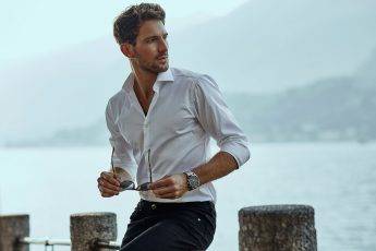 Stylish man in white classic shirt, looking at the mountains view
