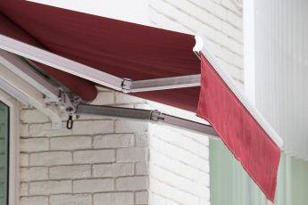 red awning over window of shop.