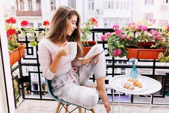 indoor-activities-to-try-this-summer-girl-sitting-at-outdoor-balcony-at-home-main-image