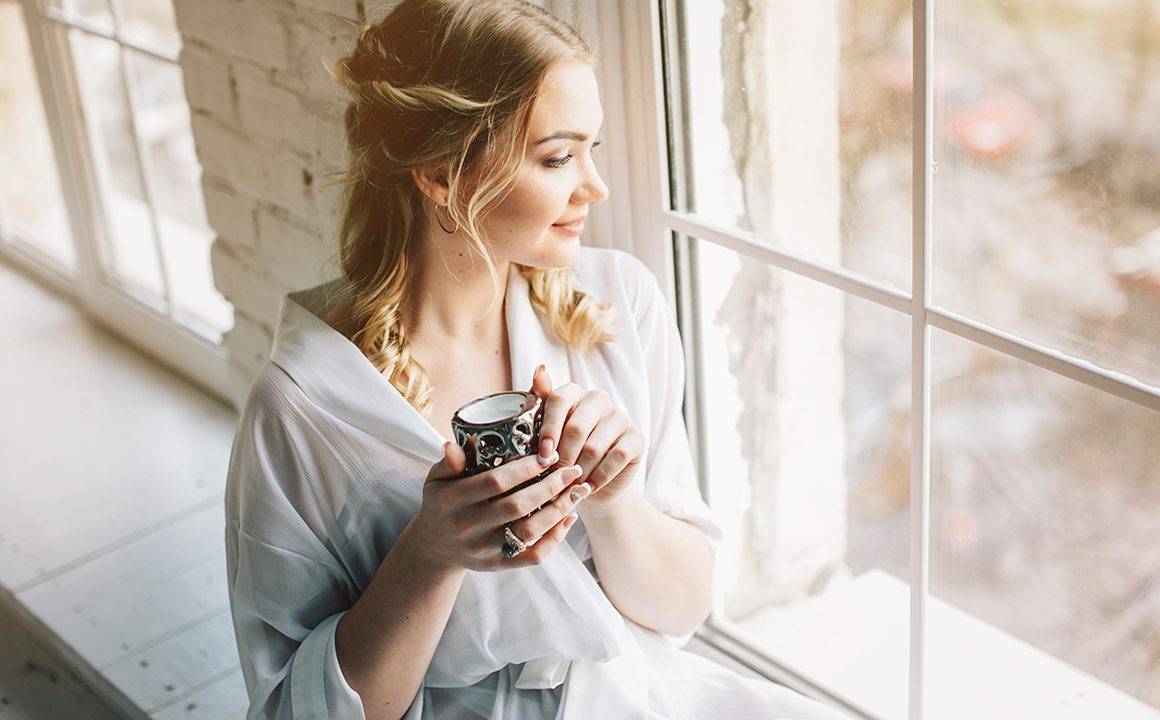 sheer-fashion-trend-woman-in-sheer-looking-out-the-window-drinking-coffee