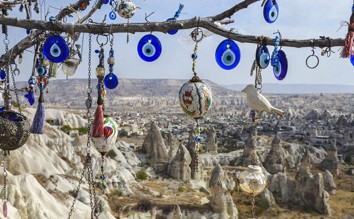evil-eye-necklaces-hanging-from-tree-in-desert-1000x600