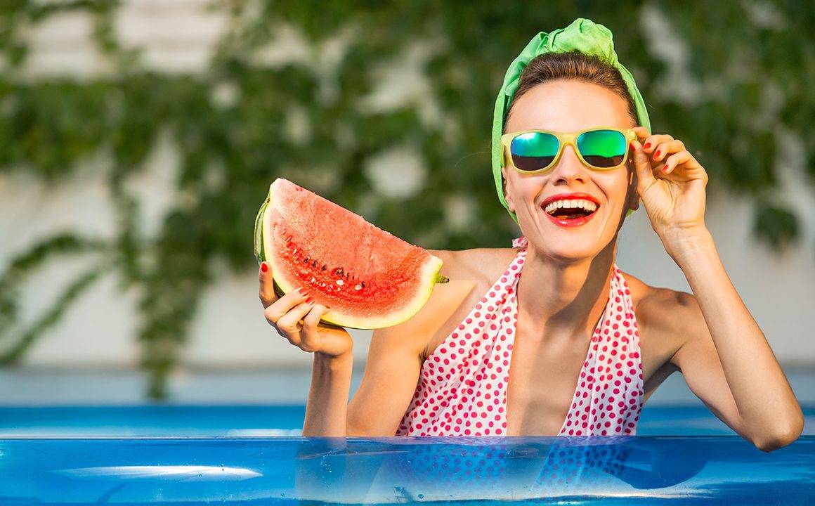 guide-to-ethical-and-eco-friendly-eyewaer-girl-in-pool-during-summer-in-glasses-holding-watermelon