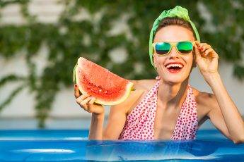 guide-to-ethical-and-eco-friendly-eyewaer-girl-in-pool-during-summer-in-glasses-holding-watermelon