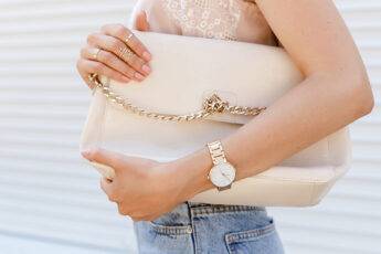 watch-design-to-match-your-outfit-woman-holding-purse-with-watch-on-main-image