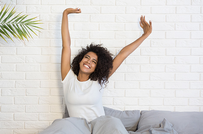 how-sleep-affects-your-physical-health-happy-woman-stretching