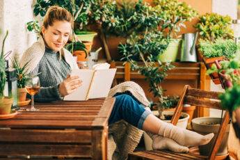 stress-busters-during-covid-woman-sitting-at-home-peacefully-reading