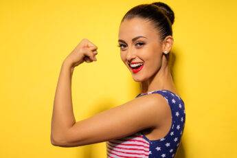 9-surprising-benefits-of-taking-probiotics-woman-flexing-arm-strength
