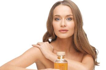makeup-tips-for-glowing-skin-woman-with-nice-skin-holding-bottle