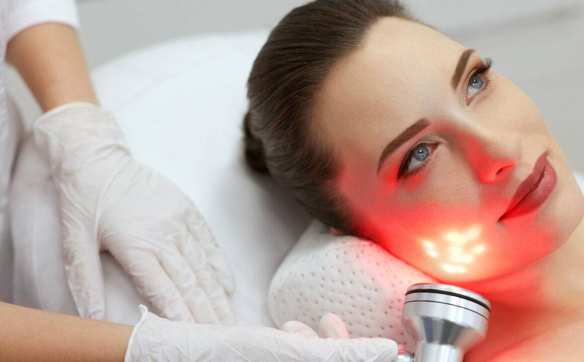 should-i-try-red-light-therapy-woman-getting-red-light-on-face