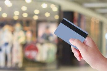 how-important-is-store-layout-to-business-success-shopper-with-credit-card-infront-of-store