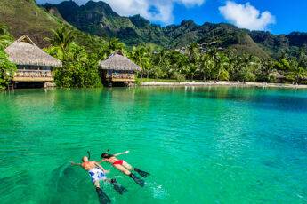 little-known-tips-for-low-cost-trips-main-image-couple-scuba-diving-tropical