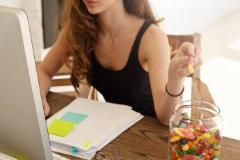 delete-your-digital-footprint-woman-snacking-with-gummies-while-on-thecomputer