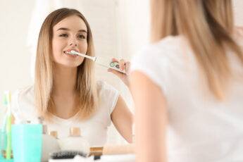 tips-for-more-effective-oral-hygene-woman-brushing-her-teeth