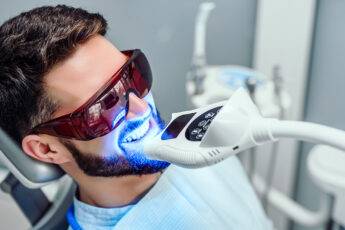 dental-cosmetic-procedures-that-bring-out-perfect-smiles-man-getting-teeth-whitened-main-image
