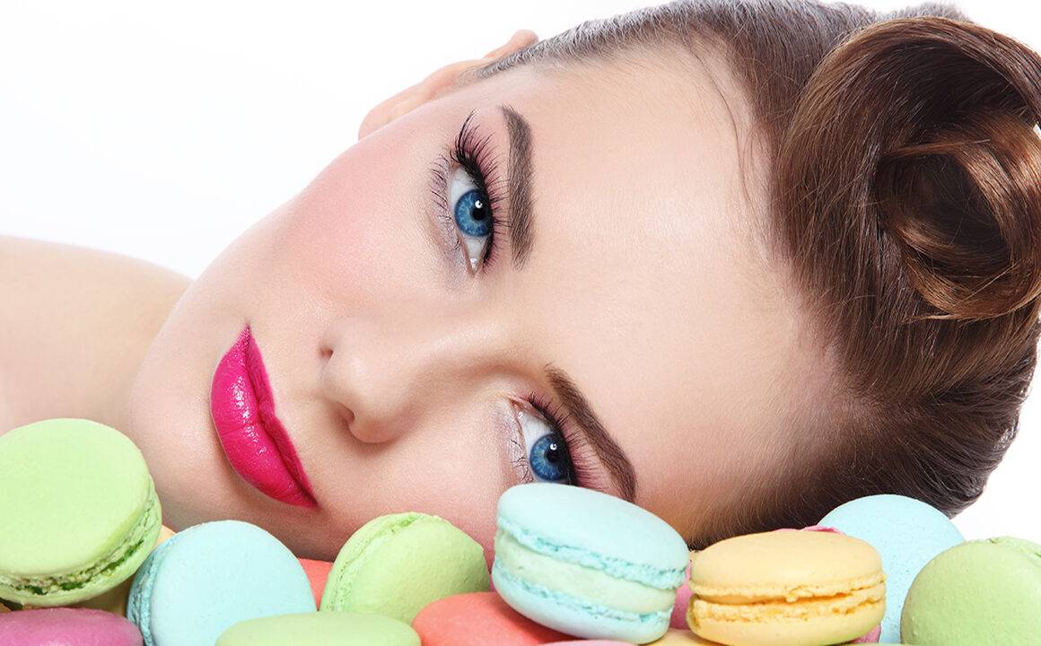 ways-to=look-more-youthful-without-surgery-woman-looking-at-colorful-macaroons
