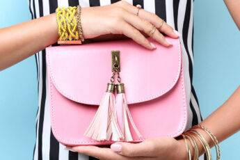 iconic-handbags-you-need-to-know-about-woman-holding-pink-handbag-main-image