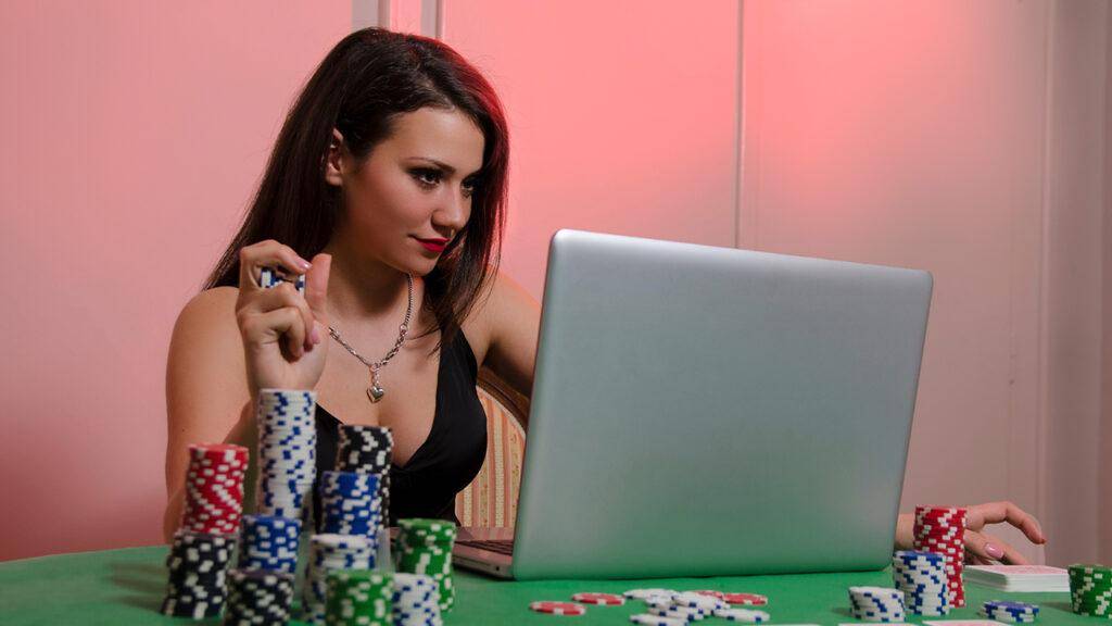 staying-safe-when-betting-online-woman-with-computer-on-poker-table-gambling-online-casino