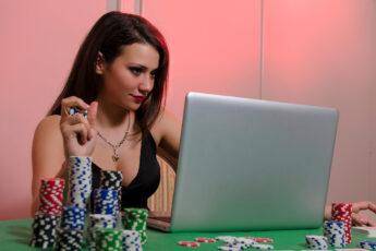 staying-safe-when-betting-online-woman-with-computer-on-poker-table-gambling-online-casino