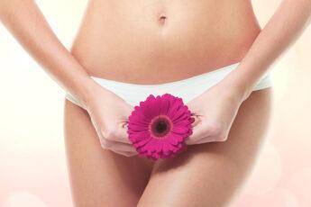 what-is-vaginal-rejuvenation-woman-holding-flower-up-to-vagina