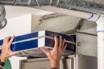 finding-the-best-furnace-filter-man-adding-filter-to-furnace
