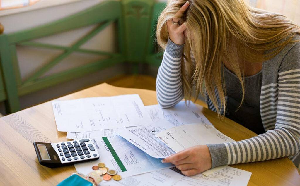 stressed-woman-paying-bills-money-debt