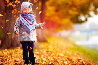 childrens-fall-fashion-girl-playing-in-fall-leaves