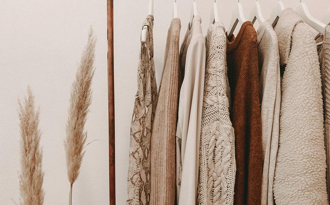 sweaters hanging on hangers
